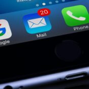 A close-up photo of a smartphone displaying popular apps like Google and Mail.