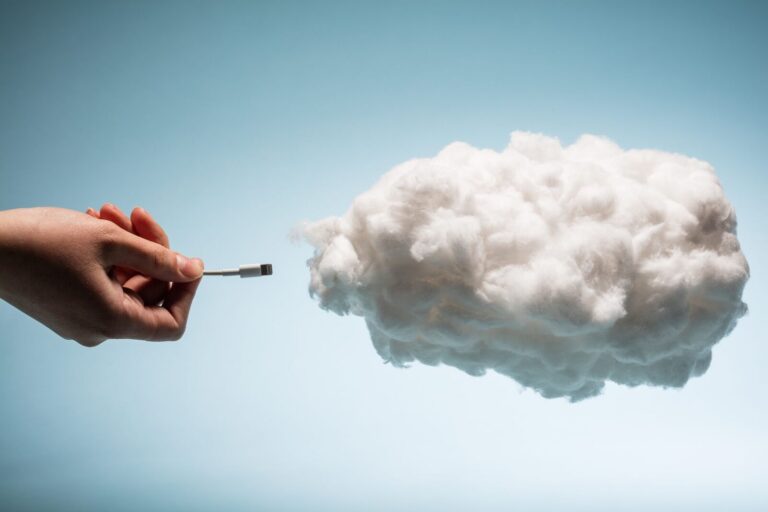 woman s hand plugging a wire into a white cloud 2025 03 26 04 29 29 utc