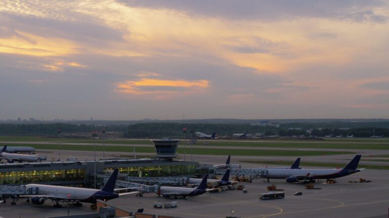 airport view with airplanes boarding and taking of 2024 10 13 22 13 04 utc